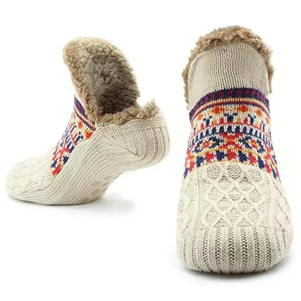 Pair of knitted socks with colorful pattern and fur lining on a white background