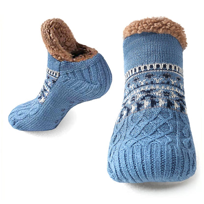 Pair of blue knitted socks with brown fuzzy lining on a white background