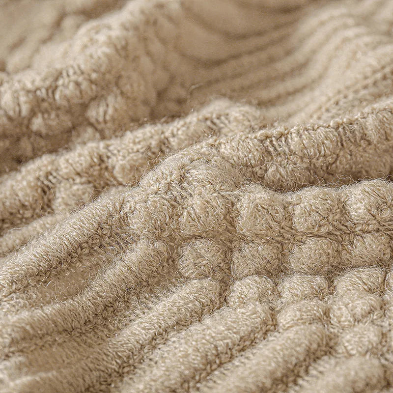 Close-up of textured beige fabric with a waffle pattern