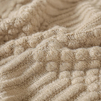 Close-up of textured beige fabric with a waffle pattern